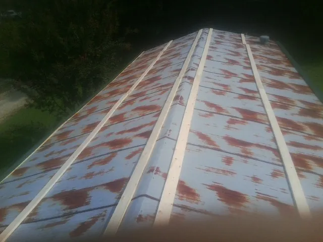 Rusted metal roof panels with new wood purlins before replacement — Storm Damage Roof Repair in Willow by Roofing Brothers